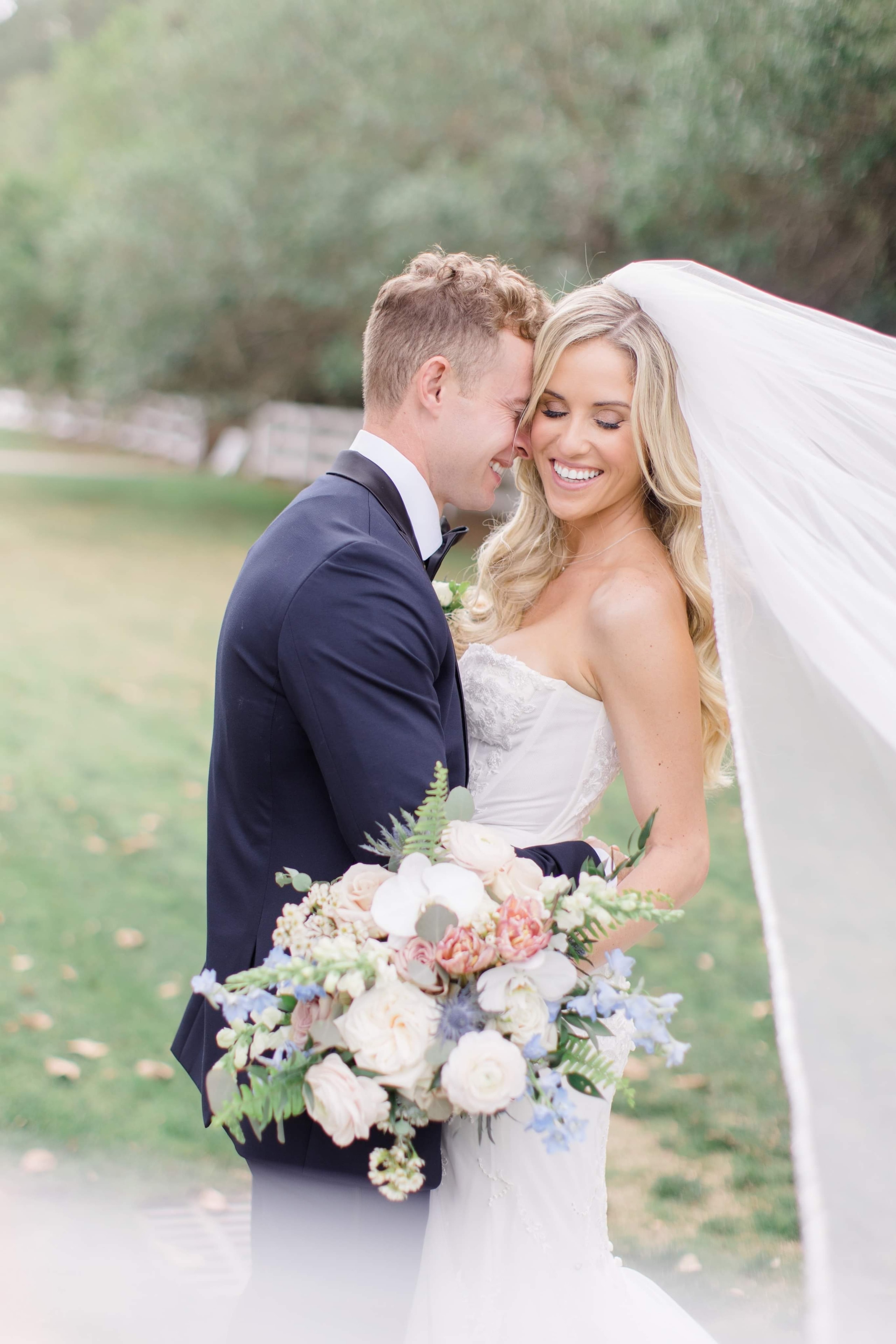 Bride smiling with bouquet